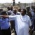 This Day's publisher Nduka Obaigbena points to a destroyed building of the newspaper during a visit by Nigerian President Goodluck Jonathan in Abuja