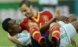 NO HARD FEELINGS•••Spain’s Roberto Soldado smiles as he falls on Super Eagles defender Azubuike Egwuekwe during their FIFA Confederations Cup match on June 23. Spain won 3-0. PHOTO: AFP